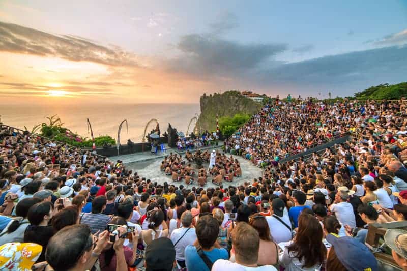 A crowd watching dancing and the sunset in Bali