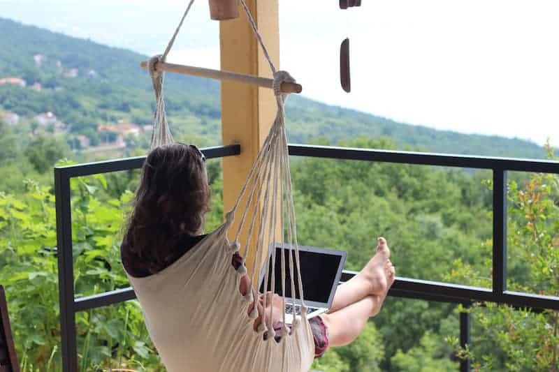Sonia working remotely in a hammock