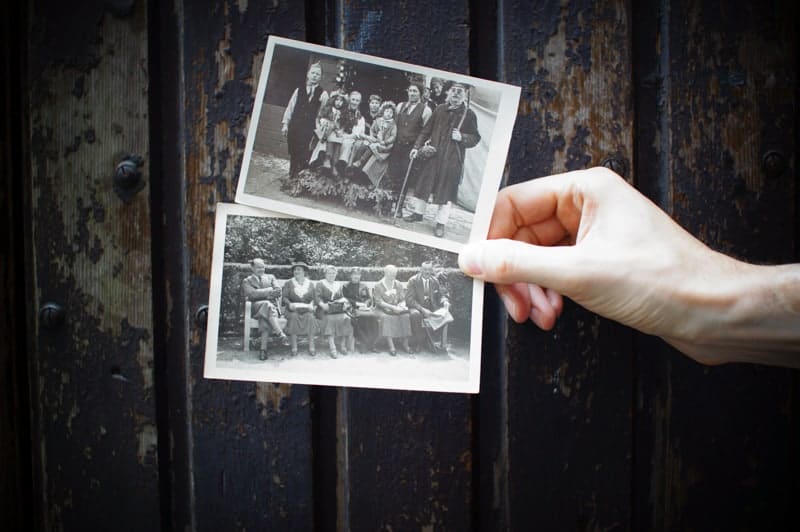 A hand holding pictures of ancestors - a great resource for the easiest countries to get citizenship in Europe.