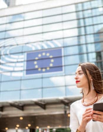 Woman in Brussels under an EU flag