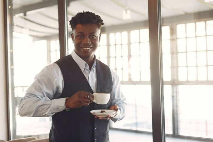 A man in a suit working on his E2 Visa in the USA