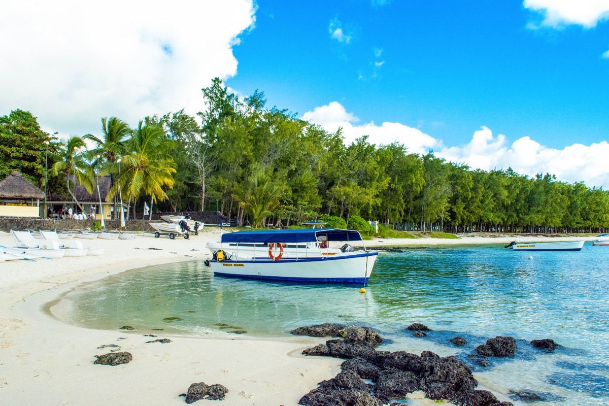 A boat in the water off a beach in Mauritius