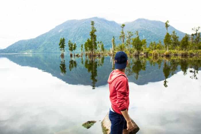 A man at a lake in the safe country of New Zealand