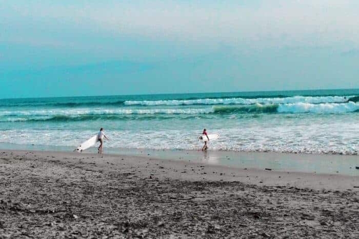 Surfers on the beach in Costa Rica.  One of the safest countries in the world