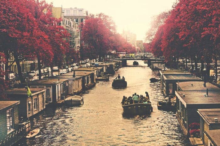 People enjoying the canals of Amsterdam, Europe.