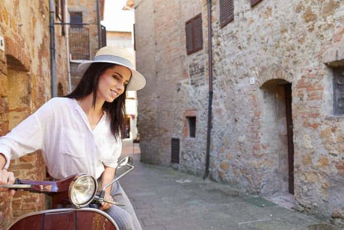 A woman on a scooter in Italy