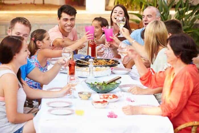 A family enjoying a lunch together enjoying living in Spain on a Golden Visa.