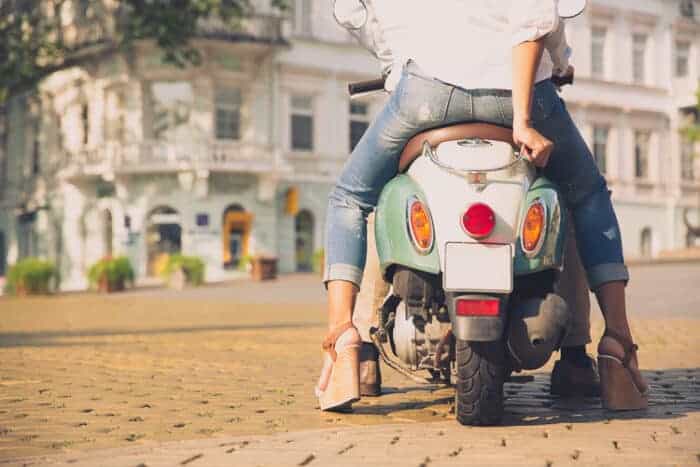 A girl on a scooter living in Italy