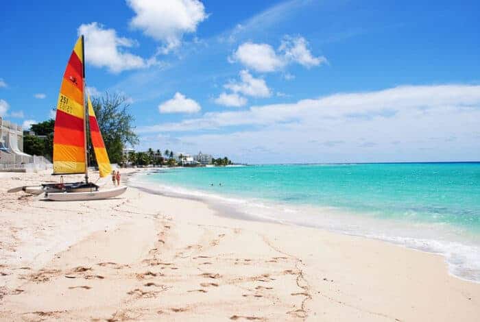 A sail boat on the beach in Barbados.  It is a popular place for Expats who all need a Barbados Visa.