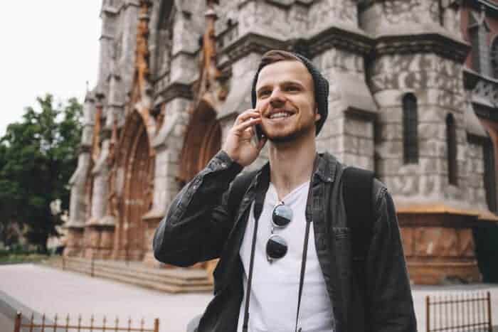 A man that is moving to Ireland talking on the phone