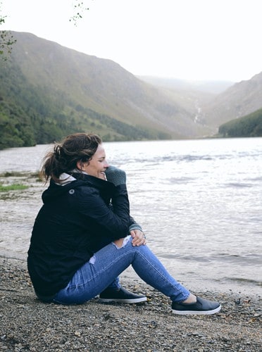 A girl walking around a lake in Ireland