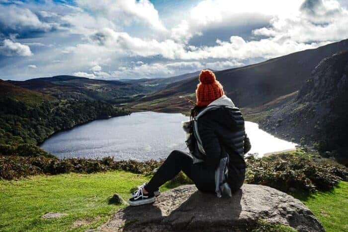 A girl in Ireland who has a resdency visa overlooking a lake.