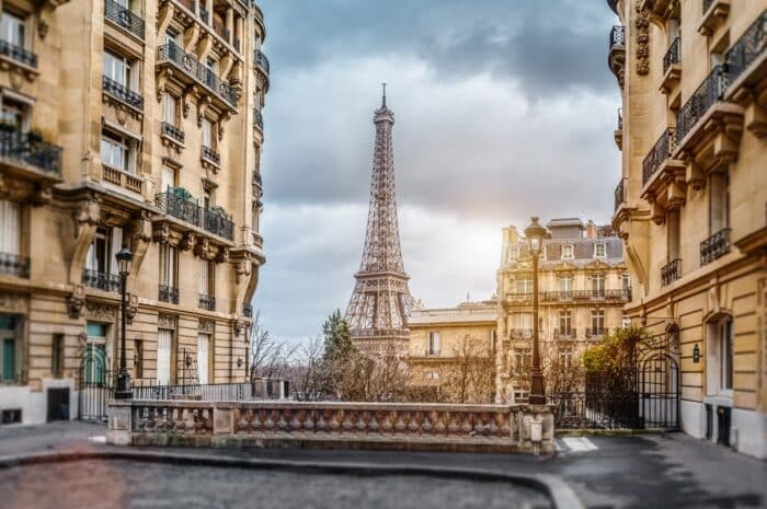 A street scene in Paris with the Eiffel Tower in the background.