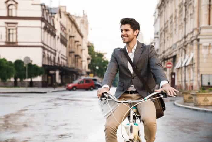 Man on a bicycle in Lisbon, Portugal on a passive income visa