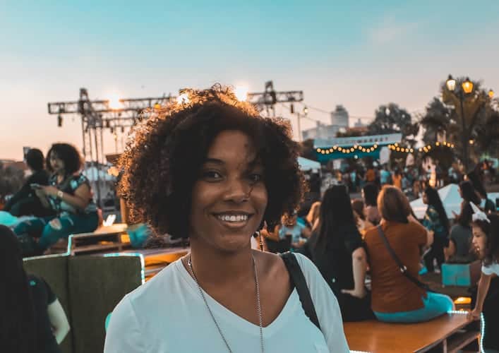 A smiling woman at a sundown concert in Panama City.