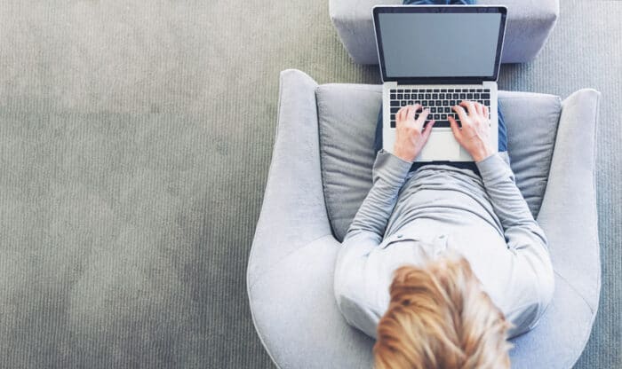 A lady on her laptop getting Health Insurance in Spain.