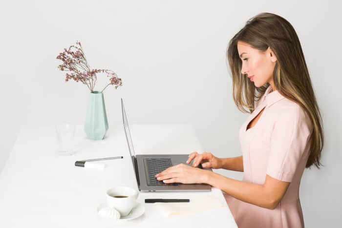 Lady working at her laptop getting the Estonia E-Residency