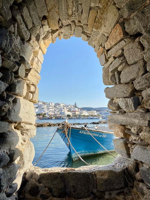 A boat seen through an archway in Greece