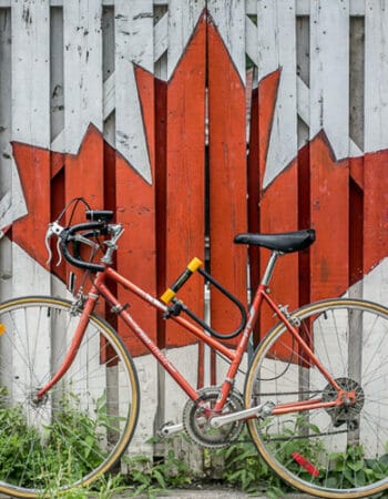 A bike in front of a maple leaf representing Canada citizenship