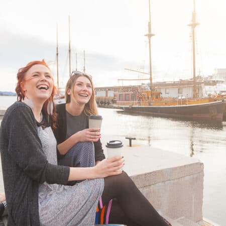 Two beautiful nordic girls enjoying living in Norway at Oslo harbour