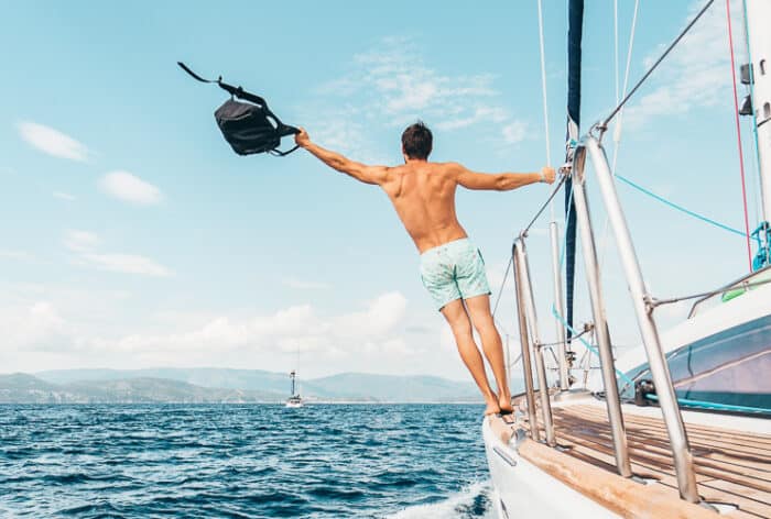 A happy man on a boat moving to Greece