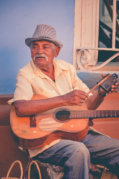 An old Puerto Rican Man playing the guitar
