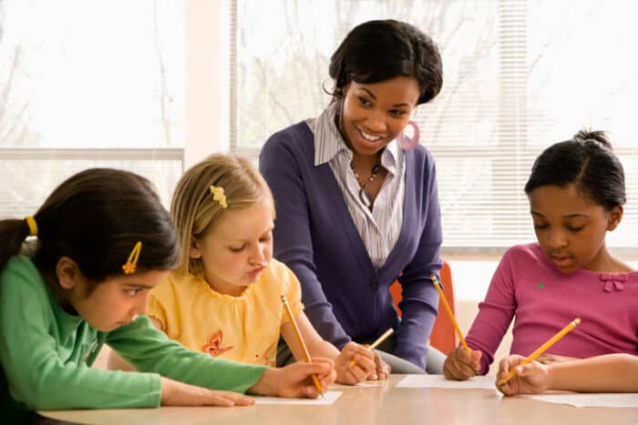 A teacher helping students in class