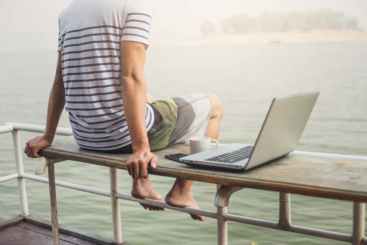 A remote worker with his laptop living in Europe on a freelancer visa